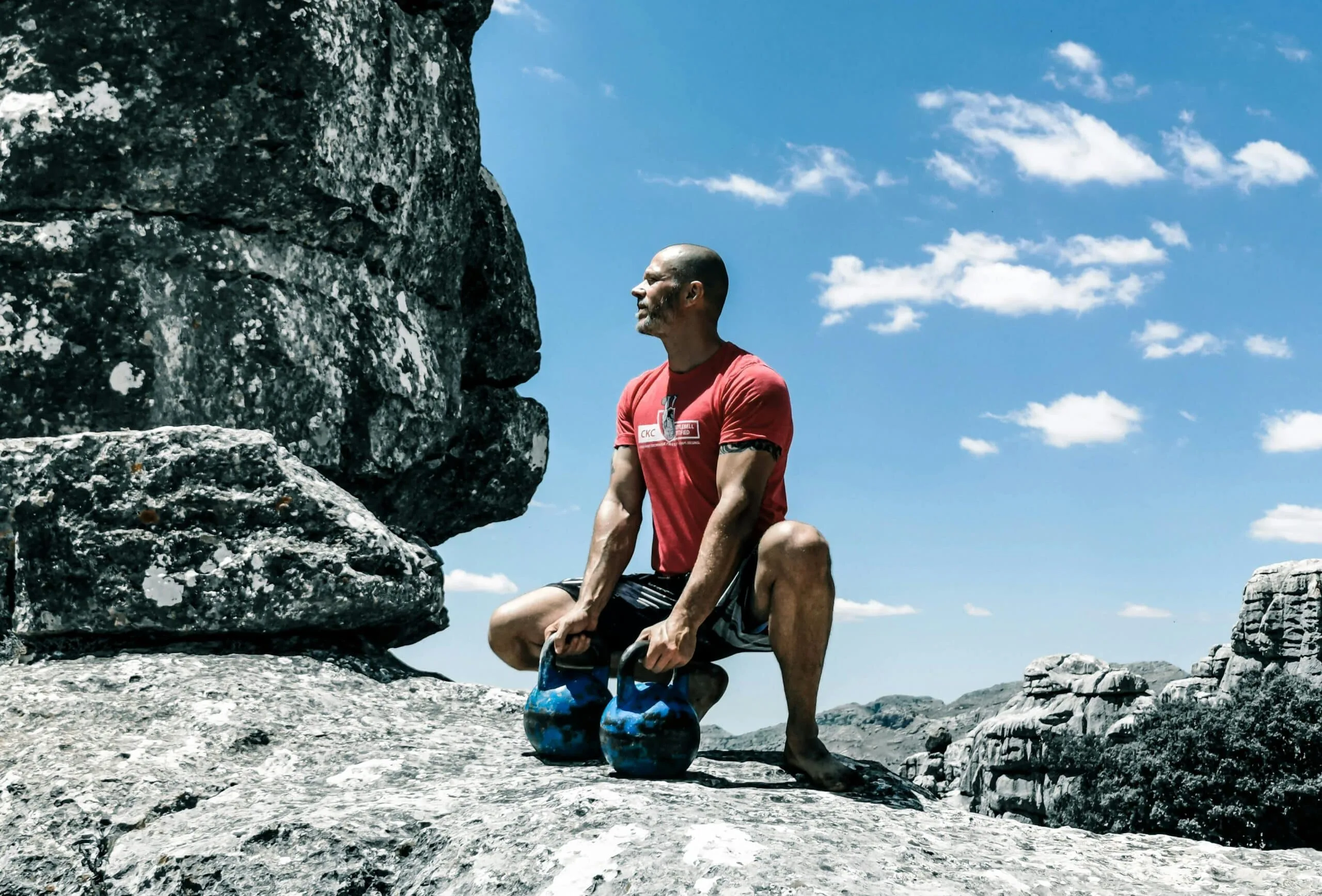 A fit man in a red shirt outdoors, representing the connection between testosterone levels and arsenic exposure from diet.